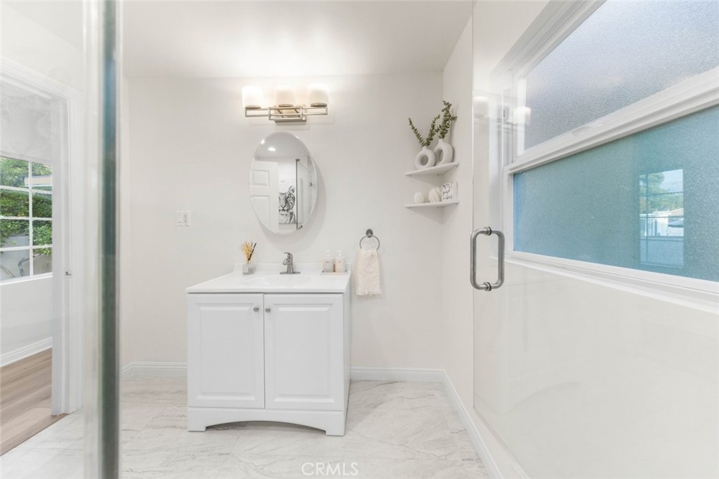 10554 Plainview Avenue Tujunga, CA 91042 - Photo 20 of 56 a bathroom with a sink a mirror and shower