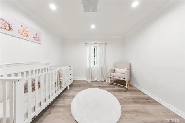 a view of a hallway with wooden floor and entryway