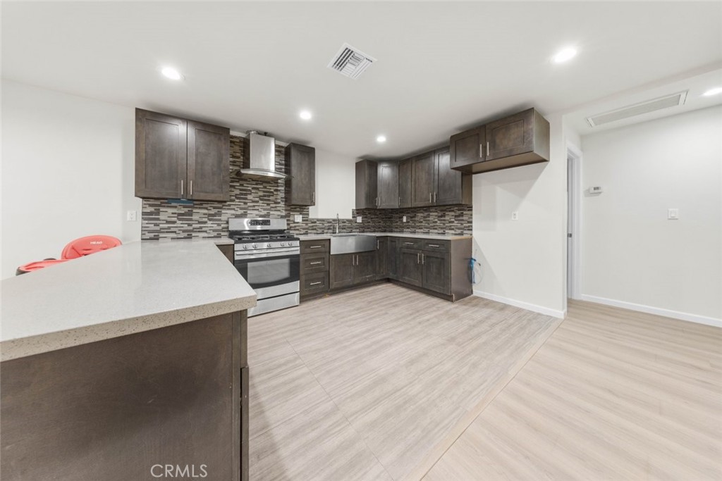 10554 Plainview Avenue Tujunga, CA 91042 - Photo 33 of 56 a kitchen with stainless steel appliances kitchen island granite countertop a refrigerator and a stove top oven