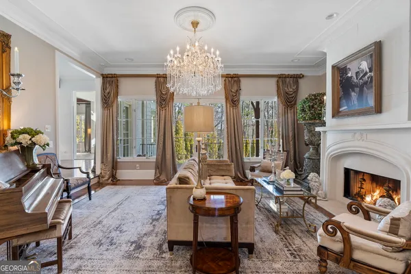a living room with furniture and floor to ceiling windows