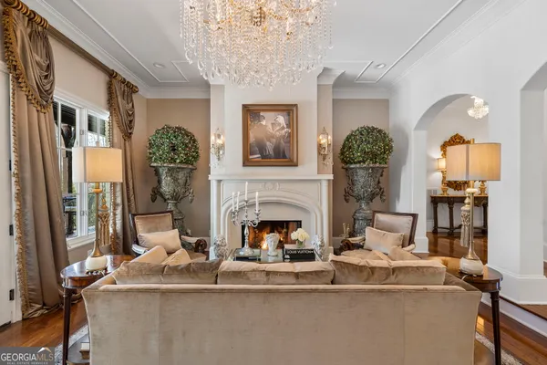 a dining room with furniture a chandelier and window