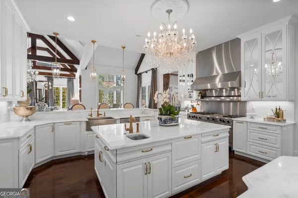 a living room with furniture and chandelier