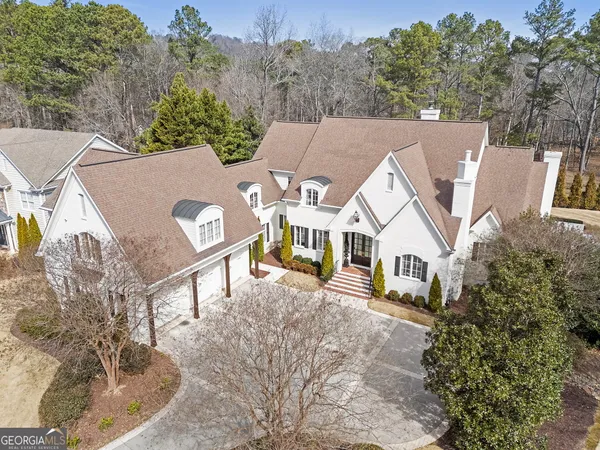 an aerial view of a house with a yard