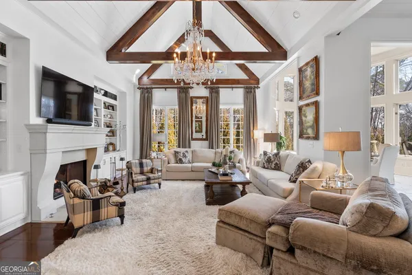a bedroom with bed and a chandelier