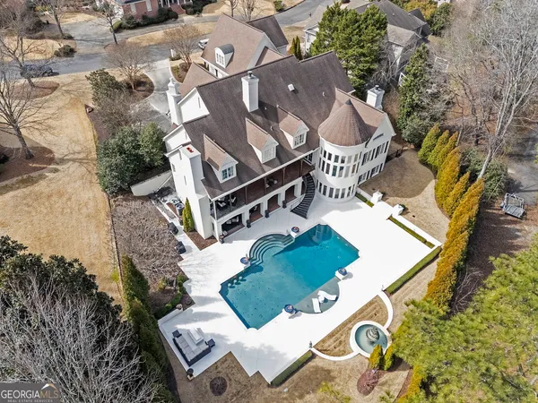 an aerial view of a house with a yard