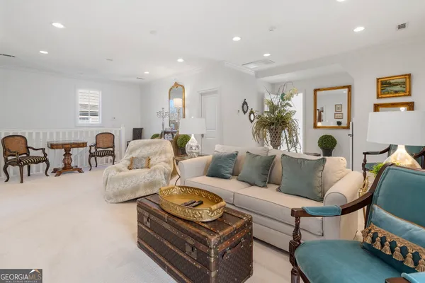 a living room with furniture or chandelier and a wooden floor