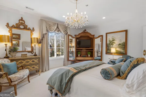 a living room with furniture chandelier and a window