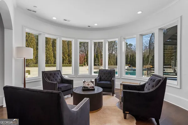 a living room with furniture a fireplace and a floor to ceiling window