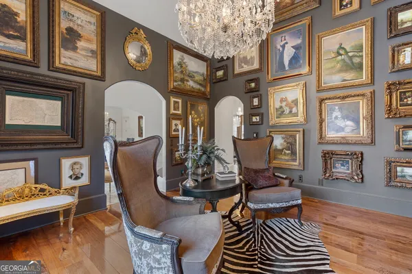 a view of a dining room with furniture and a chandelier