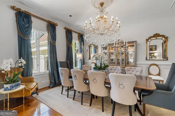 a living room with furniture a fireplace and a chandelier