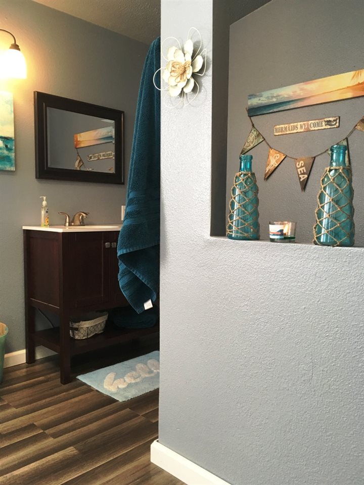 3708 2000 Road Delta, CO 81416 - Photo 27 of 42 a view of a hallway with wooden floor and paintings on the wall