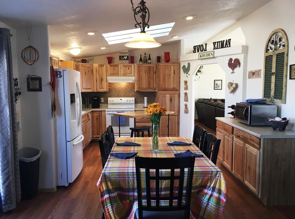 3708 2000 Road Delta, CO 81416 - Photo 9 of 42 a dining room with stainless steel appliances a dining table and chairs