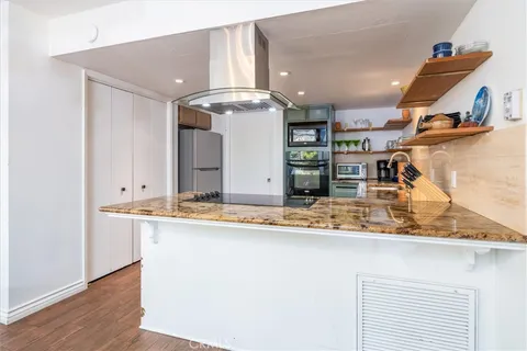 a en suite bathroom with a granite countertop sink and a mirror