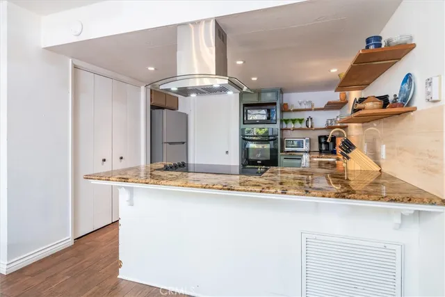 a en suite bathroom with a granite countertop sink and a mirror