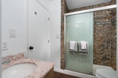 a bedroom with a bed wooden floor and a window