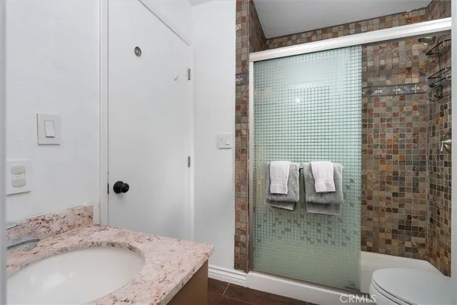 a bedroom with a bed wooden floor and a window