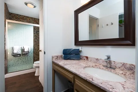 a bedroom with a bed a couch and a painting on the wall