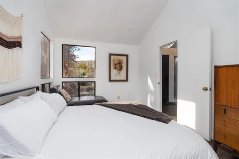 a bedroom with furniture and a window