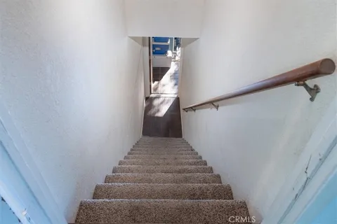 a view of a balcony with wooden floor and fence
