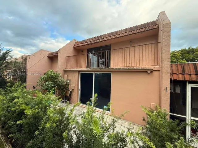 a view of a house with wooden fence