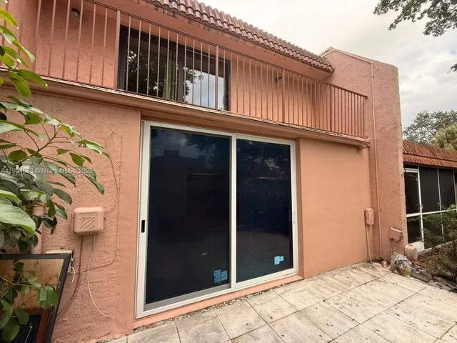 a view of a house with a wooden fence