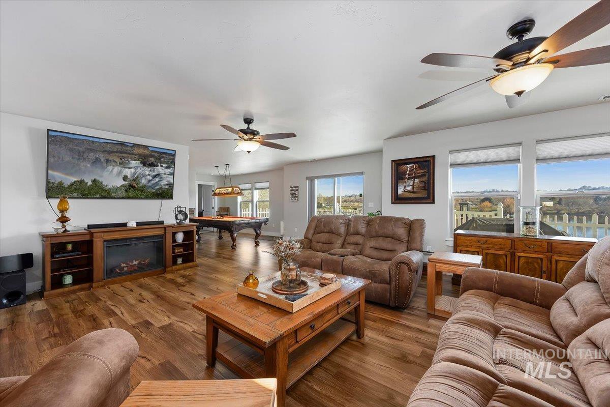 40 Bell Rapids Road Hagerman, ID 83332 - Photo 13 of 50 Living area with pool table, wood finished floors, ceiling fan, and a glass covered fireplace