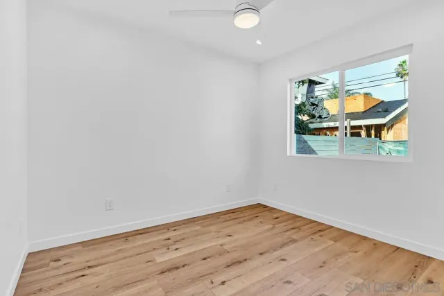 a view of kitchen with refrigerator cabinets and wooden floor