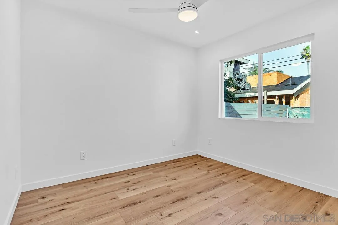 4922 Muir Avenue San Diego, CA 92107 - Photo 15 of 69 a view of empty room with wooden floor and fan
