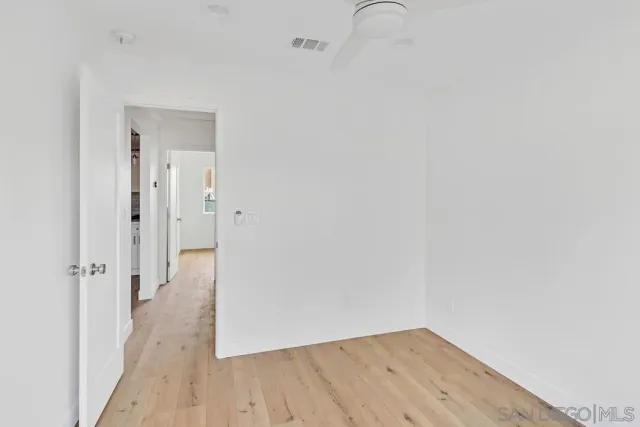 a kitchen with white cabinets and sink