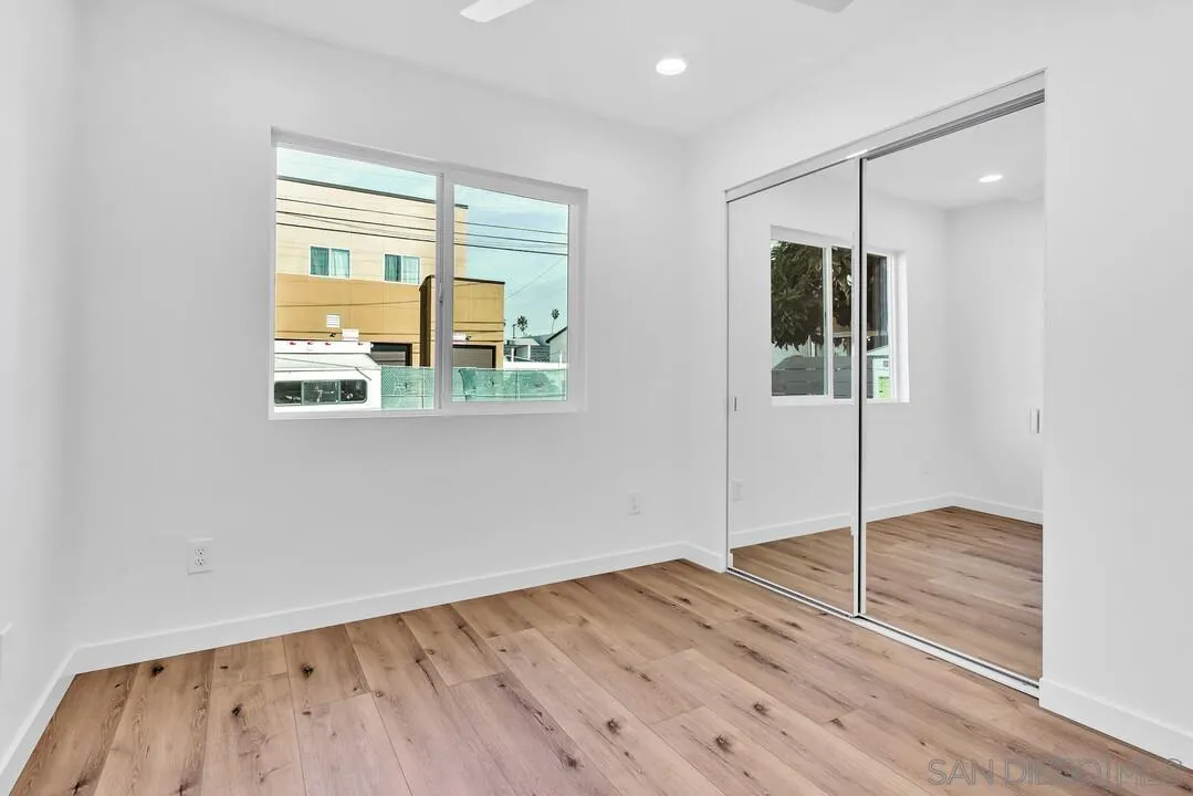 4922 Muir Avenue San Diego, CA 92107 - Photo 27 of 69 a view of an empty room with wooden floor and a window