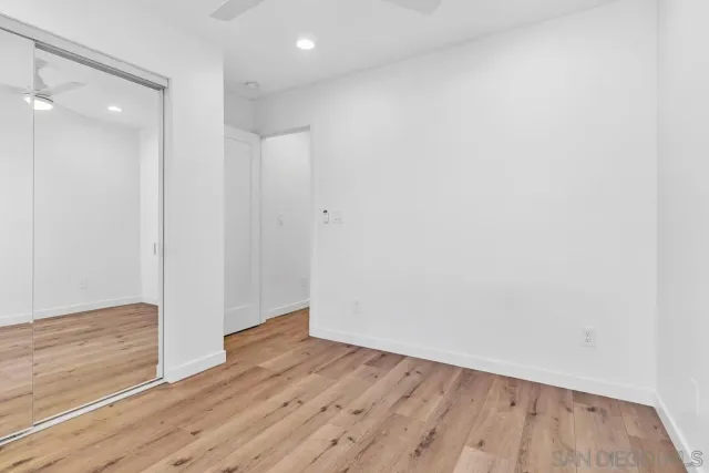 a view of a bedroom with a bed and cabinet