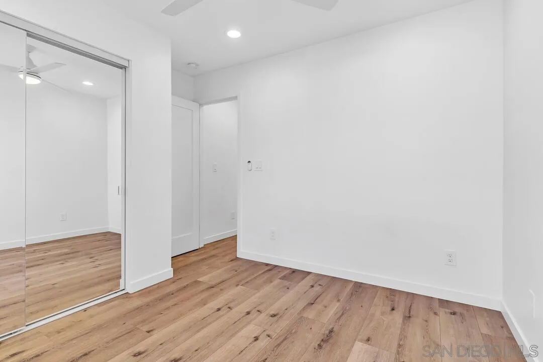 4922 Muir Avenue San Diego, CA 92107 - Photo 28 of 69 a view of an empty room with wooden floor and closet