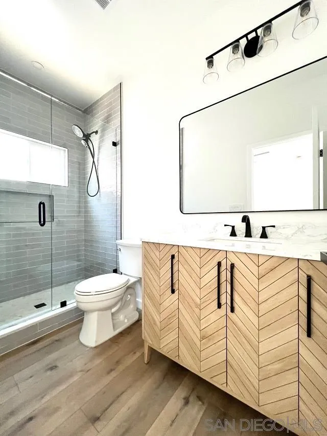 4922 Muir Avenue San Diego, CA 92107 - Photo 43 of 69 a white toilet sitting next to a bathroom sink