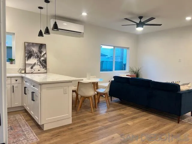 4922 Muir Avenue San Diego, CA 92107 - Photo 50 of 69 a living room with stainless steel appliances kitchen island a table chairs and a sink
