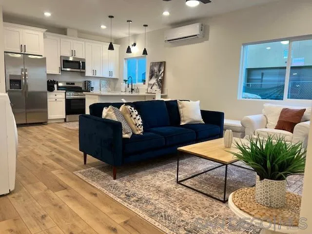 4922 Muir Avenue San Diego, CA 92107 - Photo 58 of 69 a living room with stainless steel appliances kitchen island granite countertop a couch and a view of kitchen appliances