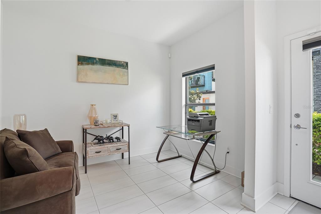 4810 West McElroy Avenue, Unit 30 Tampa, FL 33611 - Photo 8 of 43 a living room with furniture and a window