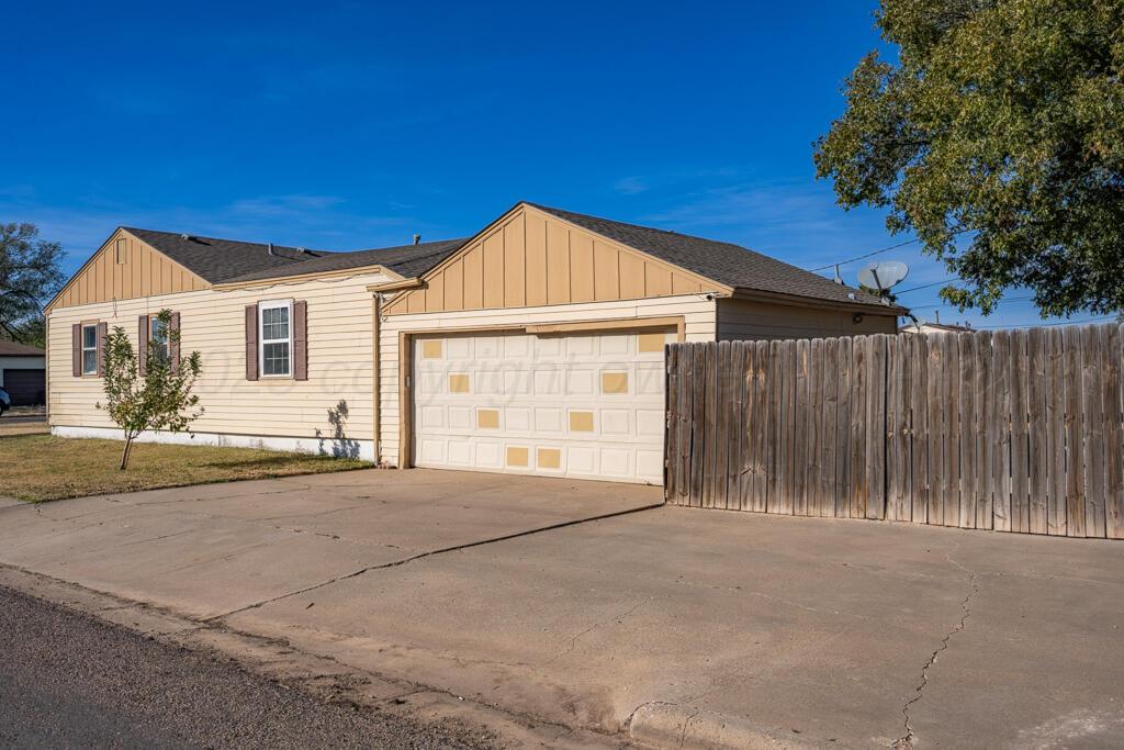 4319 South Lipscomb Street Amarillo, TX 79110 - Photo 13 of 28 a view of a house with a backyard and a garage