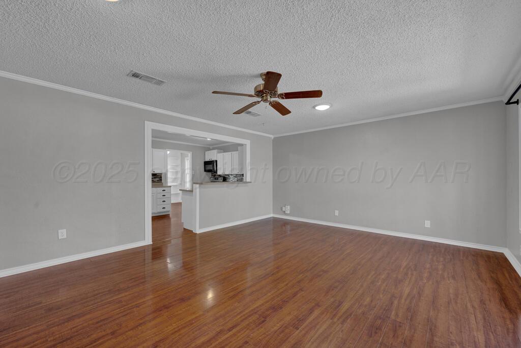 4319 South Lipscomb Street Amarillo, TX 79110 - Photo 17 of 28 a view of empty room with wooden floor and ceiling fan