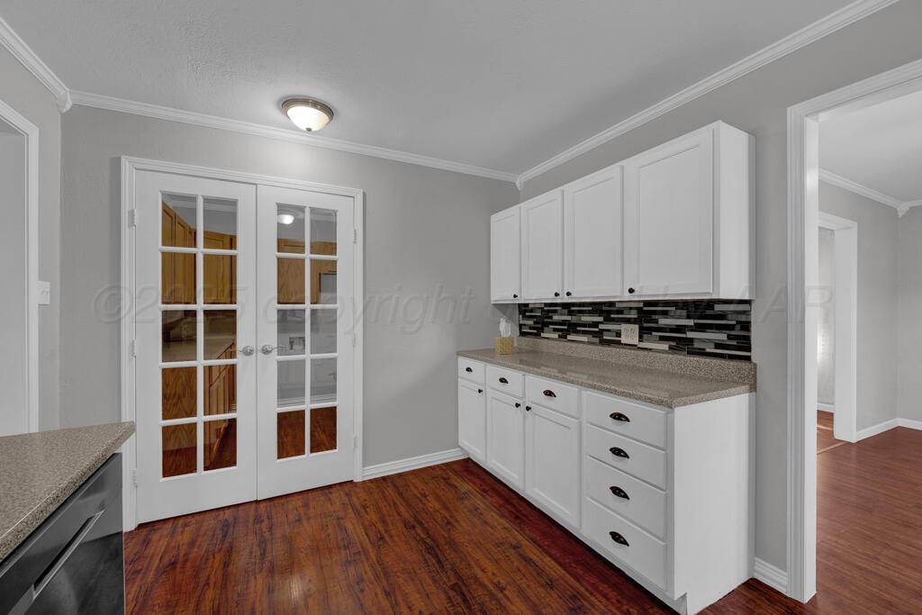 4319 South Lipscomb Street Amarillo, TX 79110 - Photo 19 of 28 a view of a kitchen with wooden floor and cabinets