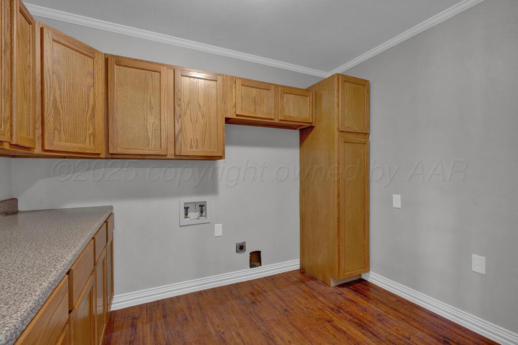 4319 South Lipscomb Street Amarillo, TX 79110 - Photo 20 of 28 a view of a kitchen with wooden floor and cabinets