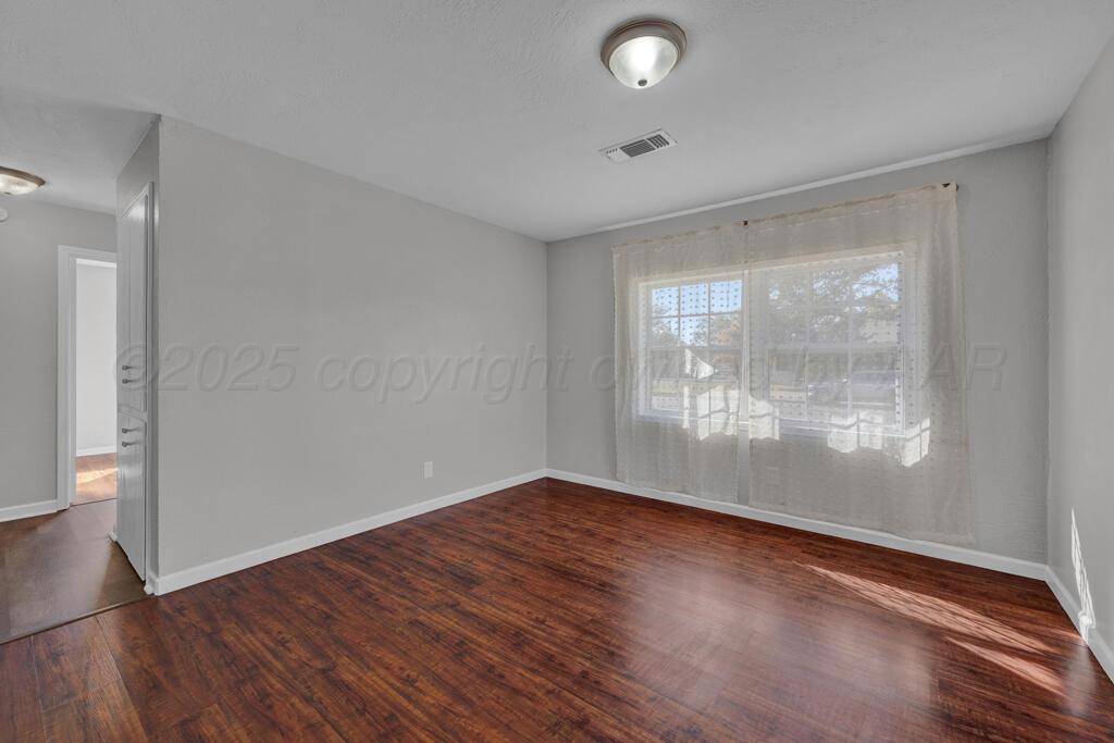 4319 South Lipscomb Street Amarillo, TX 79110 - Photo 2 of 28 a view of empty room with wooden floor and fan