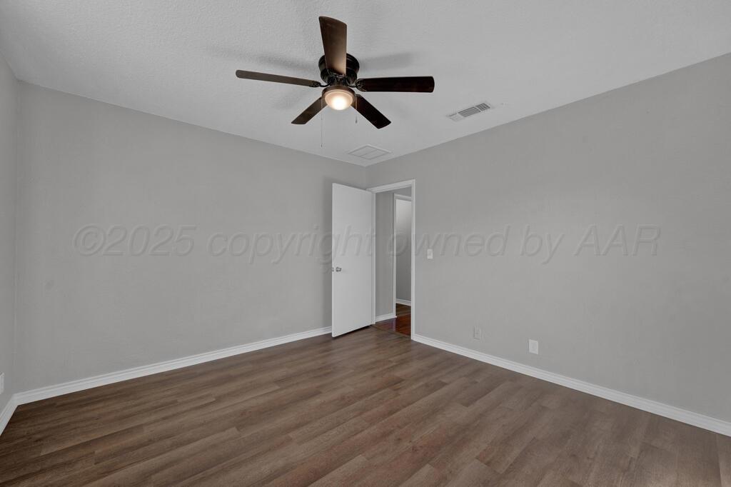 4319 South Lipscomb Street Amarillo, TX 79110 - Photo 22 of 28 a view of empty room with wooden floor and ceiling fan