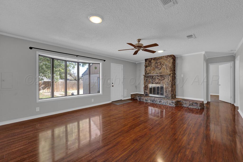 4319 South Lipscomb Street Amarillo, TX 79110 - Photo 3 of 28 a view of an empty room with wooden floor and a window