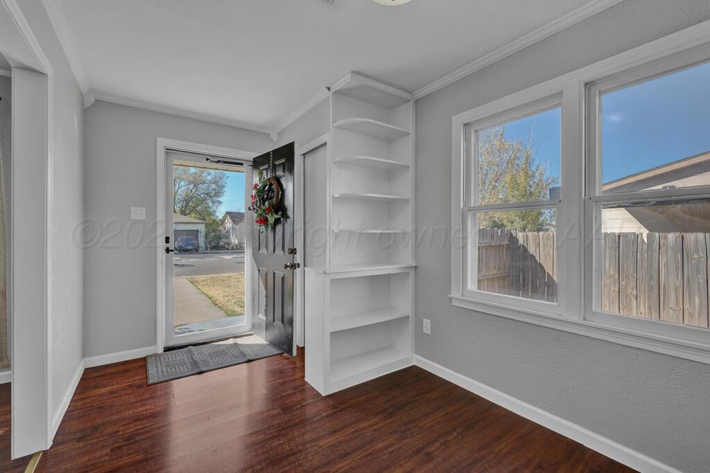 4319 South Lipscomb Street Amarillo, TX 79110 - Photo 6 of 28 a view of an empty room with a window and wooden floor