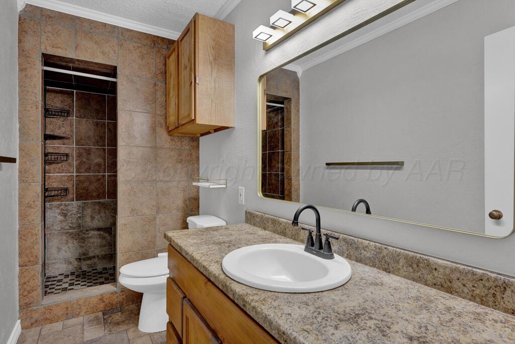 4319 South Lipscomb Street Amarillo, TX 79110 - Photo 8 of 28 a bathroom with a granite countertop sink toilet and shower