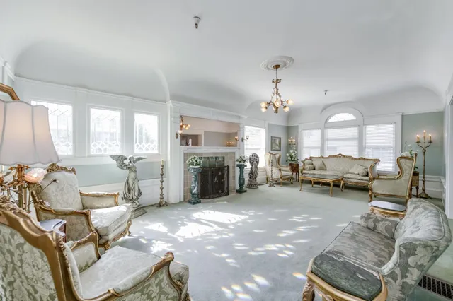 a living room with furniture and a mirror