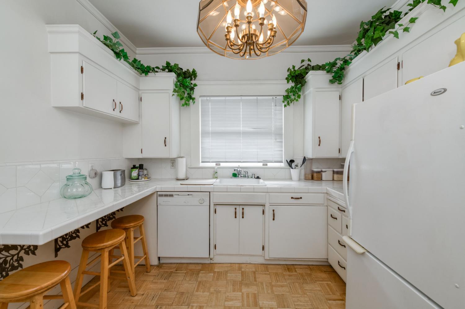 916 East Divisadero Street Fresno, CA 93721 - Photo 16 of 23 a kitchen with a sink a stove a dining table and chairs