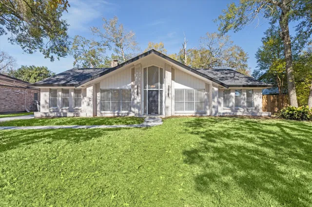 a view of a house with a yard and a garden
