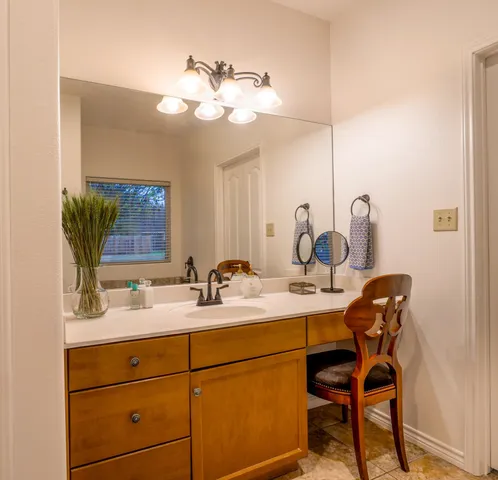 a bathroom with a double vanity sink and a mirror