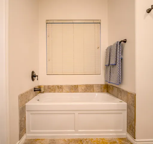 a bathroom with bathtub and shower